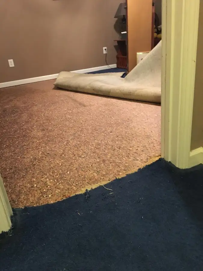 Carpet pad removal revealing water damage during Drying & Dehumidification in Calimesa
